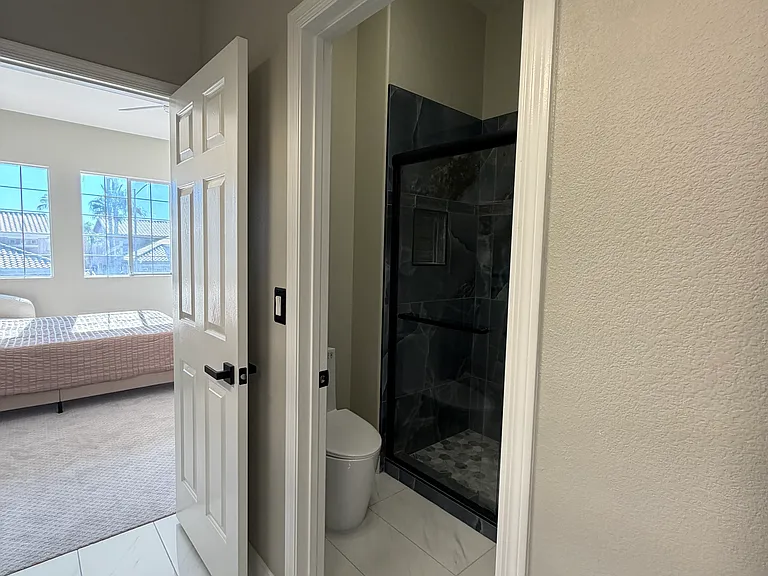 Jack-and-Jill bathroom with separate, private shower and toilet