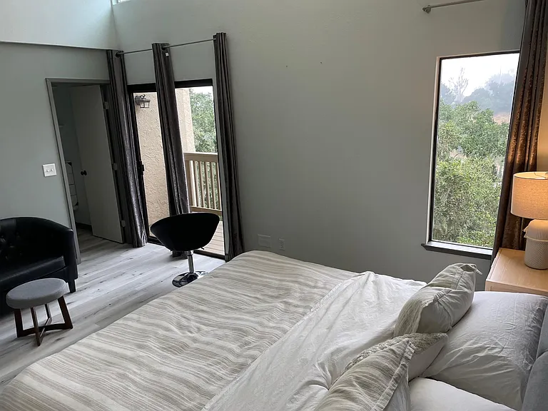 Master bedroom and adjoining deck overlooking greenbelt and canyon views