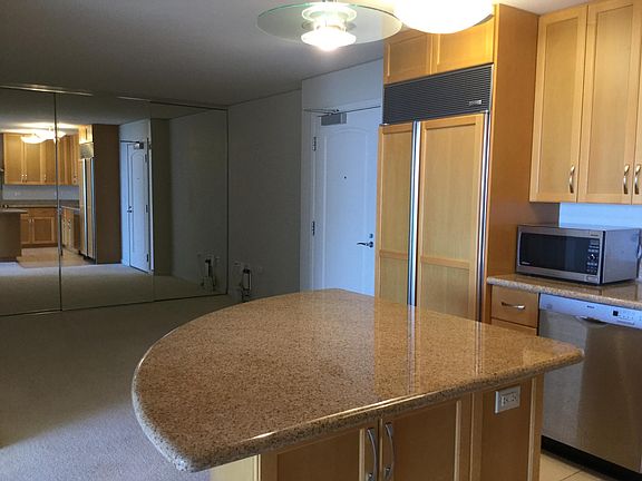 Den w/Full Width floor to ceiling Mirror Closet Island with Storage Space and Room for Bar Stools