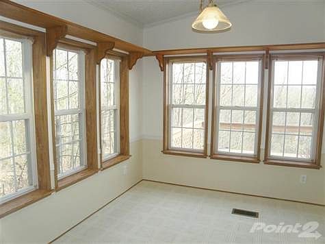 Breakfast Room off the Kitchen * Walls of Windows to Enjoy the Views! Nice Open Floor Plan to the Gathering Room with Cozy Woodburning Fireplace!