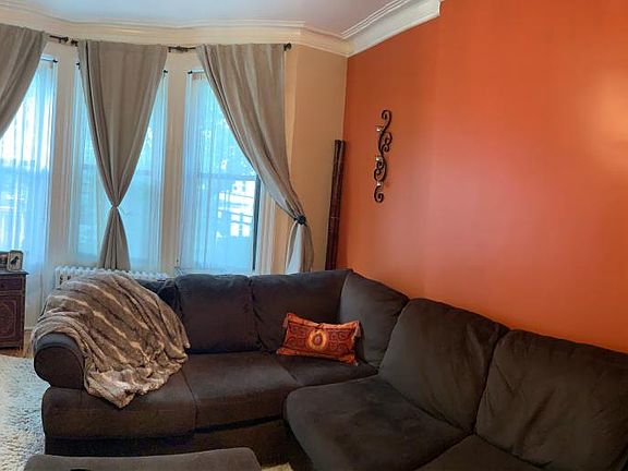 Panorama of reading room, lounge room with pocket doors to dining room.