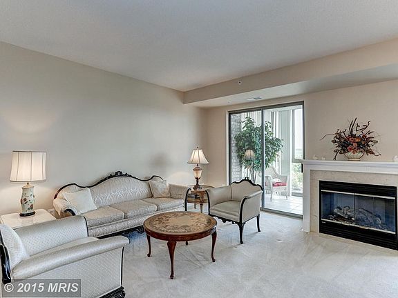 Living room flows to enclosed balcony