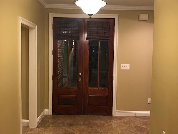 Large open foyer with French doors opening to front porch
