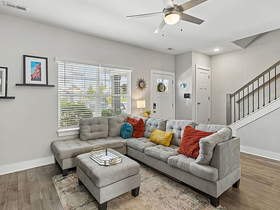 Bright open living room with luxury vinyl plank flooring and abundant natural light.