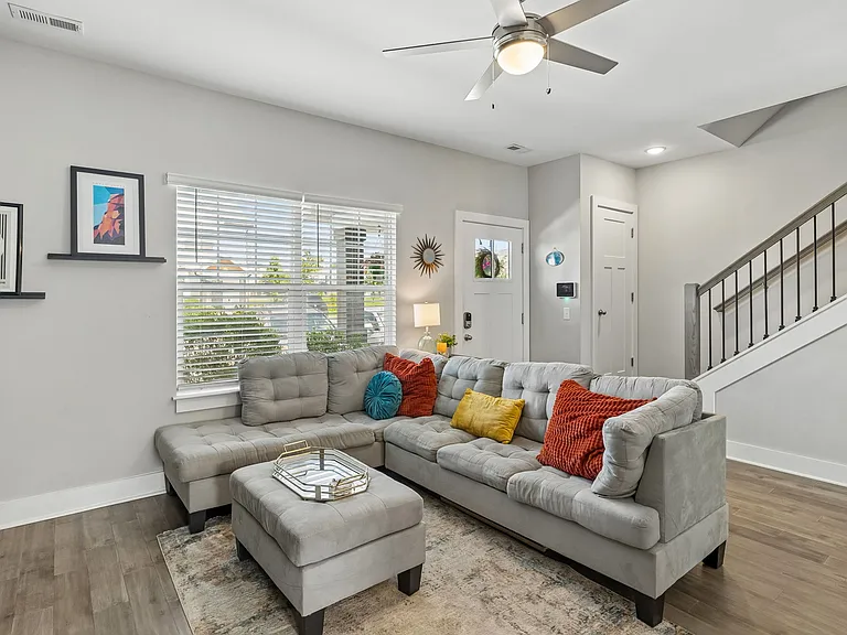 Bright open living room with luxury vinyl plank flooring and abundant natural light.
