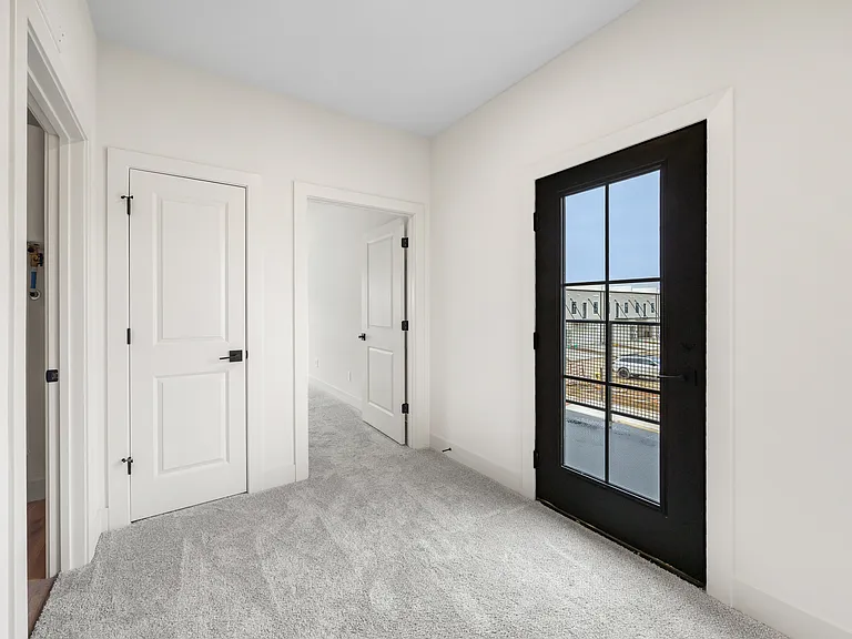 Second-story landing and entrance to balcony (2-bedroom floorplan)