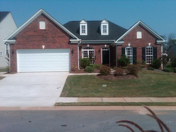 brick front and slab cover, 2 car g.,sprinkler system,no maintenance community