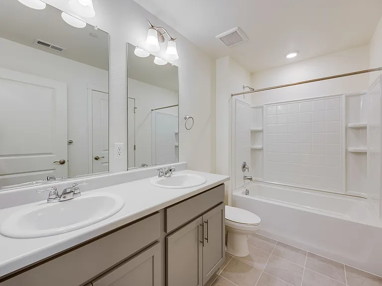 Upper full bath with double vanities and linen closet