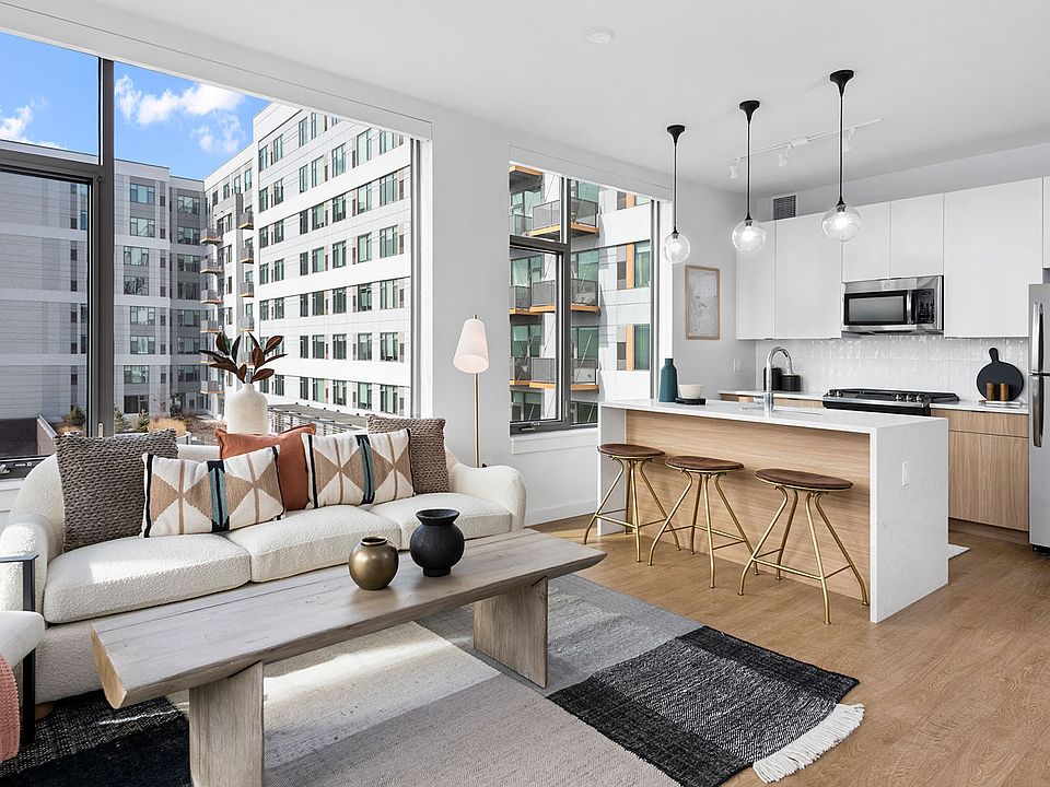 An inviting open-concept home at Eleven33, featuring sleek finishes, natural light, and a seamless flow between kitchen and living space.