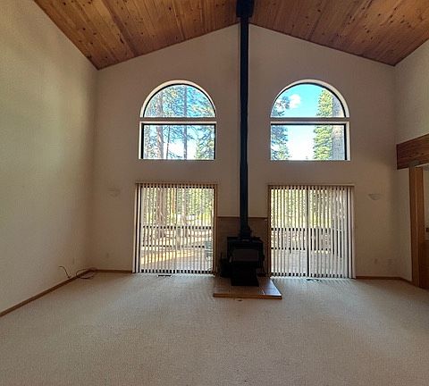 Great room with vaulted ceilings and sliding doors leading to the back deck