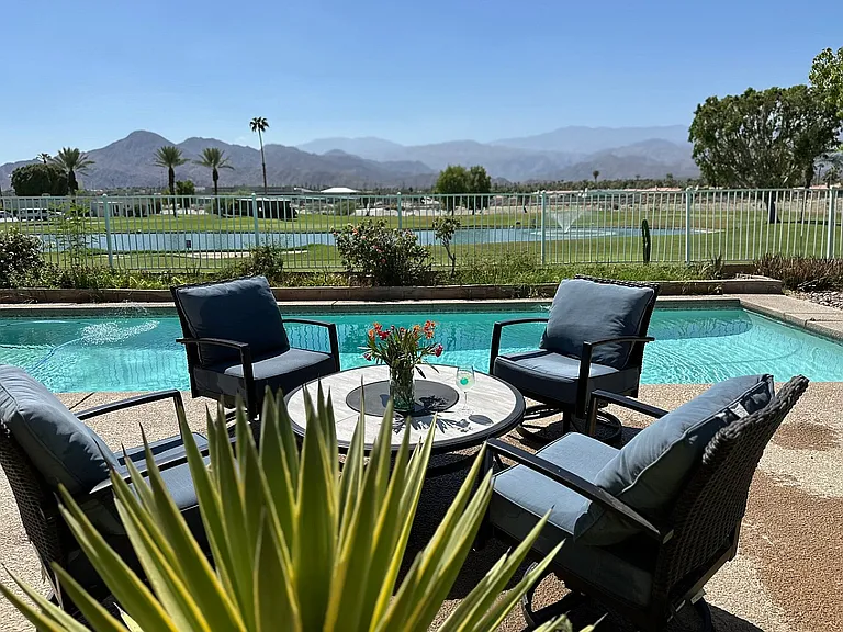 View of the golf course from the backyard and pool