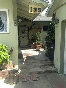 Private entryway has another door leading to Laundry/panty area with full bath. This also leads to kitchen for easy access for groceries to kitchen. The side to the right is a nice enclosed atrium.