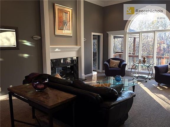 Formal Living Room with marble fireplace and huge floor to ceiling windows