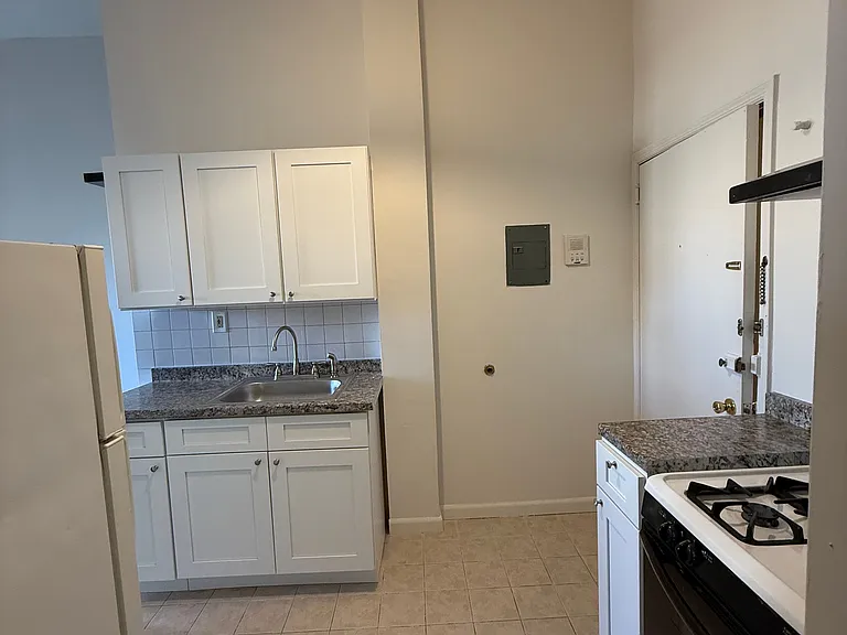 Kitchen with new cabinets and refrigerator
