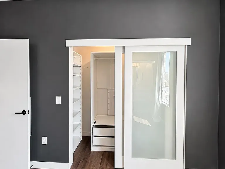 Primary Closet with frosted sliding doors