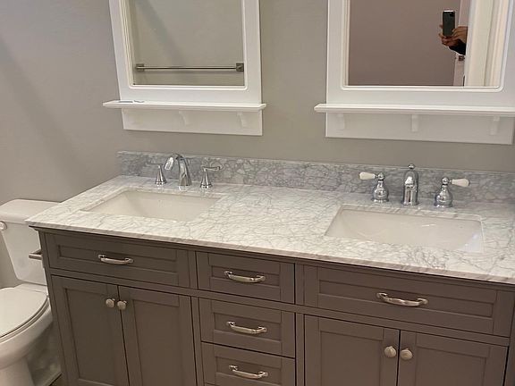Custom vanity in master bathroom w/ marble countertop.