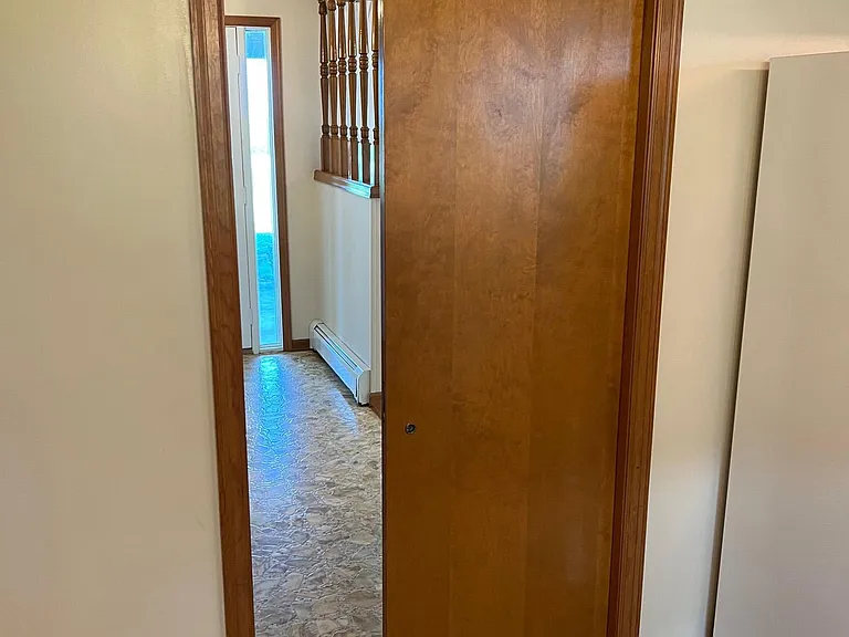 Entry hall to kitchen pocket door. 

By sliding this door shut and the living room pocket door to the family room shut, the living room/entry hall/dining room become an isolated space with pass through to the kitchen. Great for when having guests.