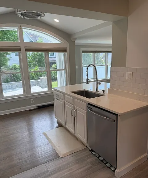 Stainless steel applicances and quartz countertops are highlight the kitchen