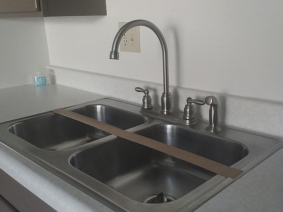 Stainless sink with high-arc faucet.