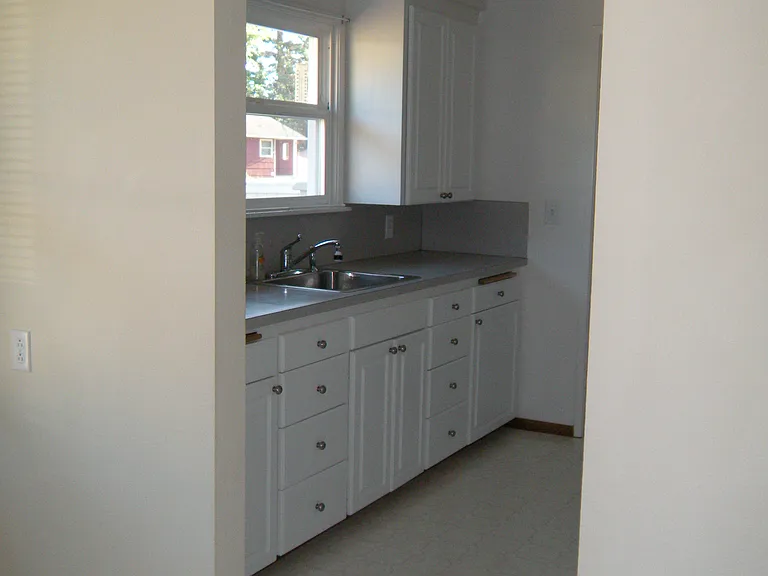 This picture is taken from the dining area into the kitchen