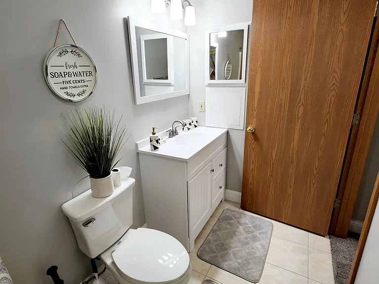 The master bathroom is thoughtfully designed for comfort and convenience, featuring a stylish 36-inch vanity with ample storage, a sleek medicine cabinet for organization, a versatile tub-shower combination, and an ADA-compliant toilet for enhanced access