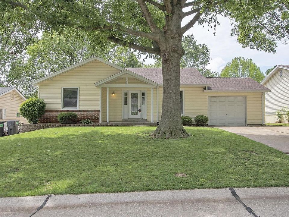 Front of house -- maintenance free brick & vinyl; new leaded glass front door with sidelights; double driveway.