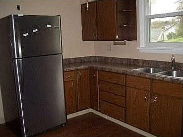 Stainless steel refrigerator and recently refinished cabinet