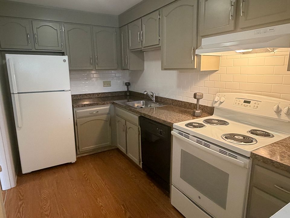 Kitchen with electric stove, dishwasher, nice cabinets and countertops.