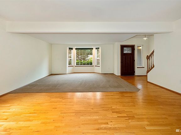 Another View of Living Room W/Carpeting & Hardwood Floors >