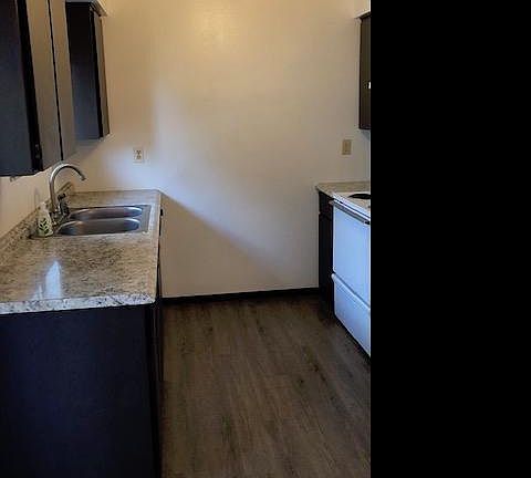 Kitchen with new plank flooring, marble patterned countertops and upgraded faucet