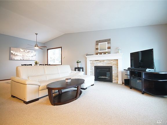 generously sized family room, newer gas fireplace with remote, freshly cleaned carpets & ceiling fan over the dining area. 