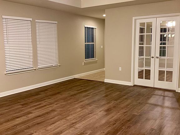 Living room with view of office doors.