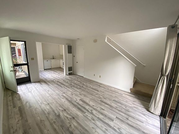 living room with walk-in closet looking towards kitchen