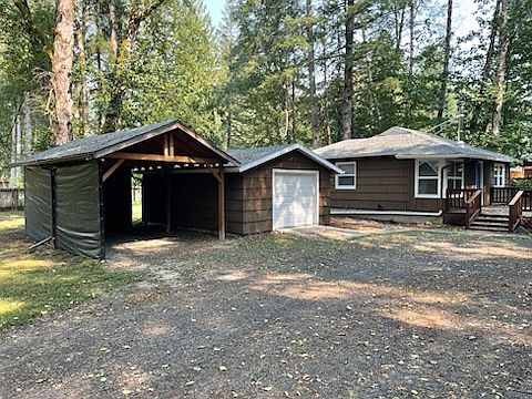 Covered Carport, Detached Garage & Home on Spacious Lot.
