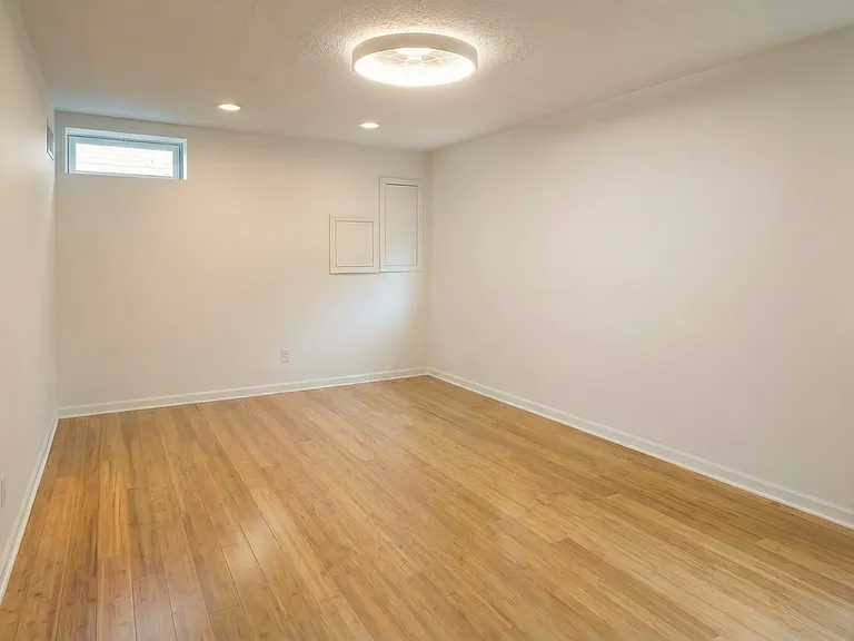 Unfurnished bedroom view showing clean walls, modern flooring, and a simple, flexible layout.