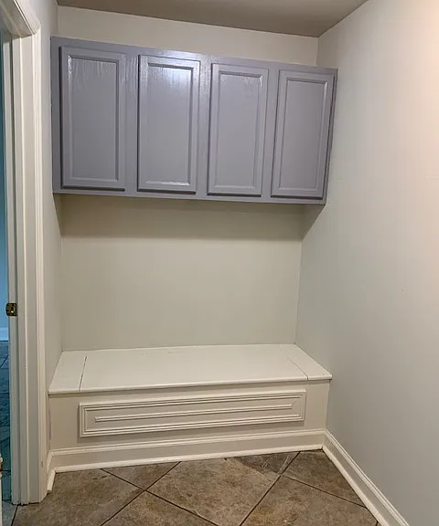Downstairs hallway with blanket box and cabinets