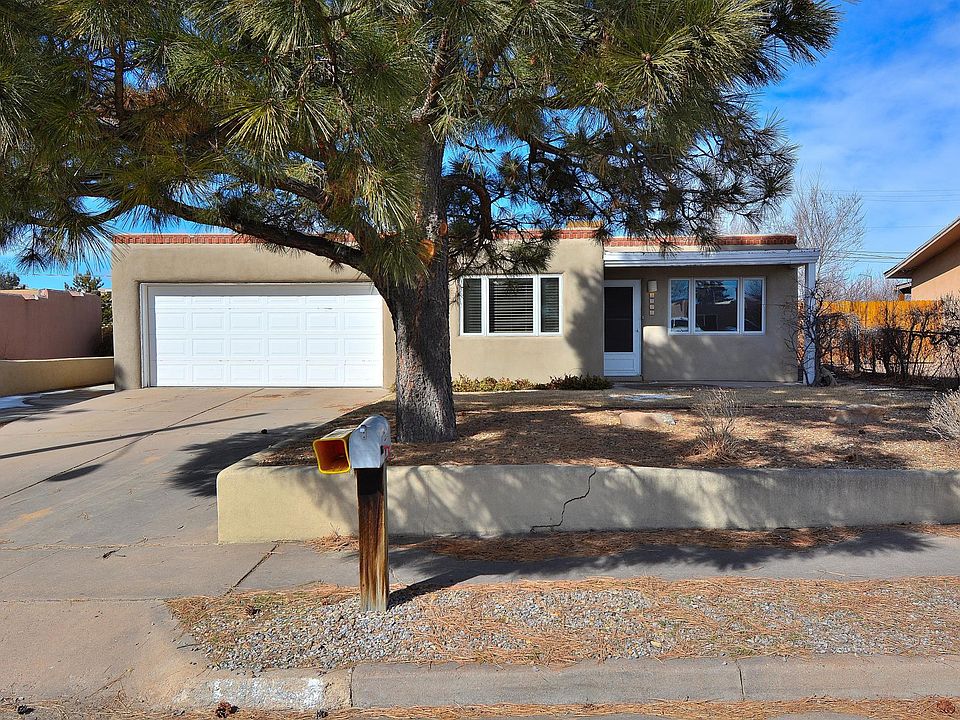 Front of home with double car garage and drip irrigation for landscaping \