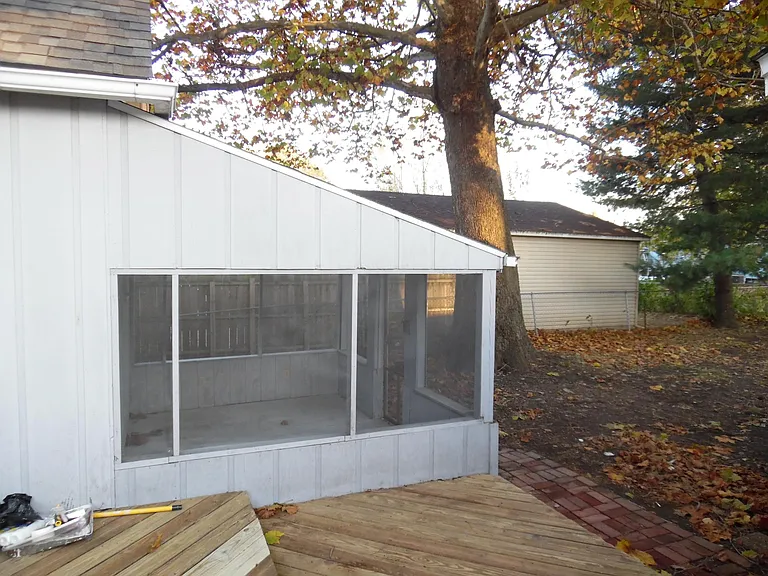 Screened in porch on back side of house