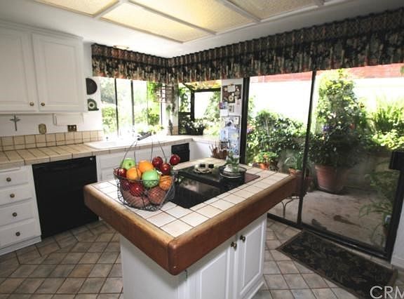Kitchen with cooktop in Island with sliding doors to patio garden