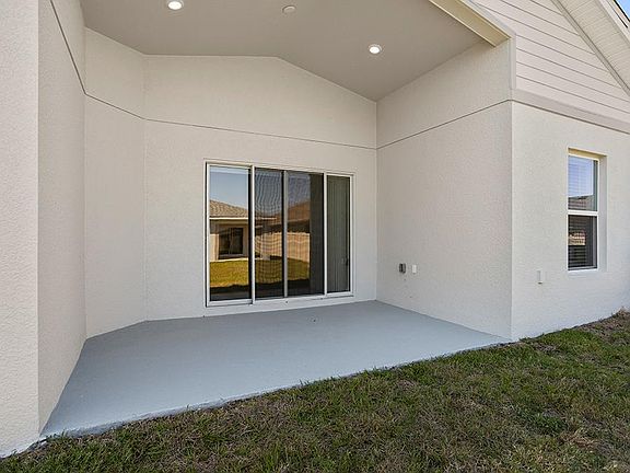 Your interior opens to outdoor living space on a covered lanai - Sophia by Highland Homes