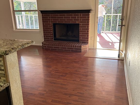 Come on into the warmth of a fireplace glowing and an open kitchen design for further entertainment as your kids play securely outside