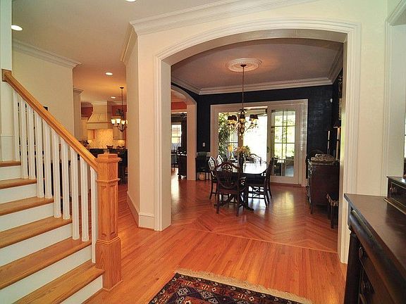 Foyer with Stairs to Second Level and Leading to Dining Room