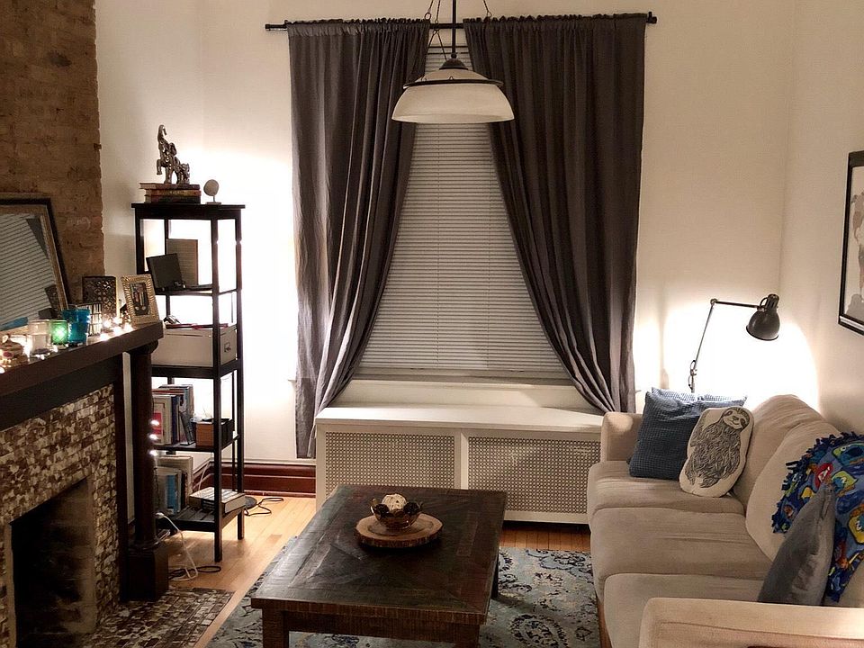 Large living room area with decorative fireplace and huge front window
