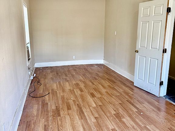 Huge Master Bedroom with six panel door, laminate floors, three windows for lots of light.