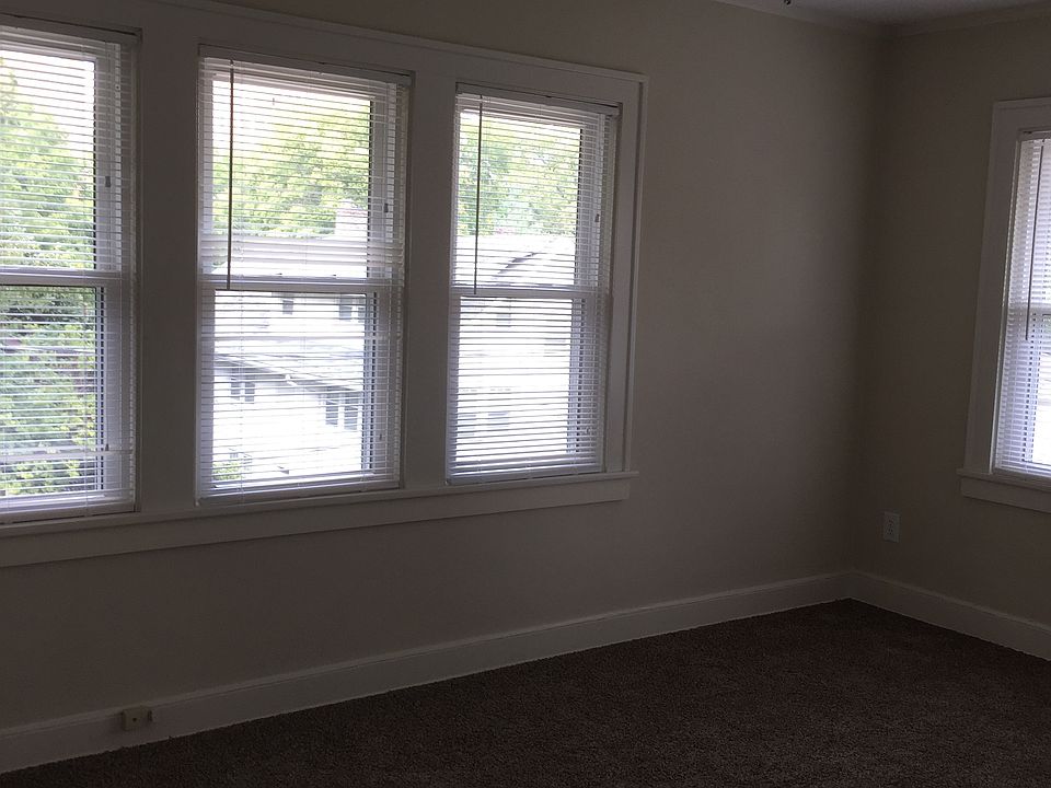 one bedroom with lots of windows
