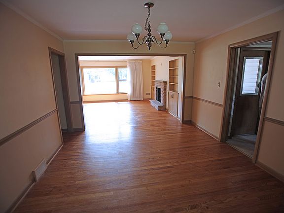 Dining Room : Looking into living room with large windows.
