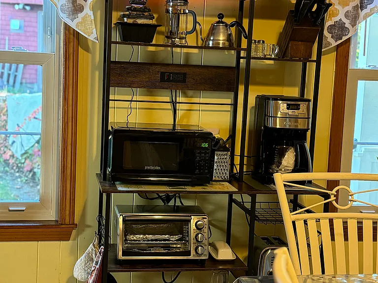 This bakes rack is housing the small appliances to keep the countertops available for cooking and baking preparations.