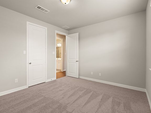 An additional view of the third bedroom with walk in closet