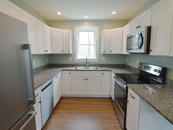 Brand new kitchen in 2022, granite counters, stainless steel appliances. Dishwasher across from the stove.