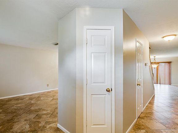 Entry opens to the Living and Formal Dining room. Tile floors flow down the hall to the Family room and Kitchen.